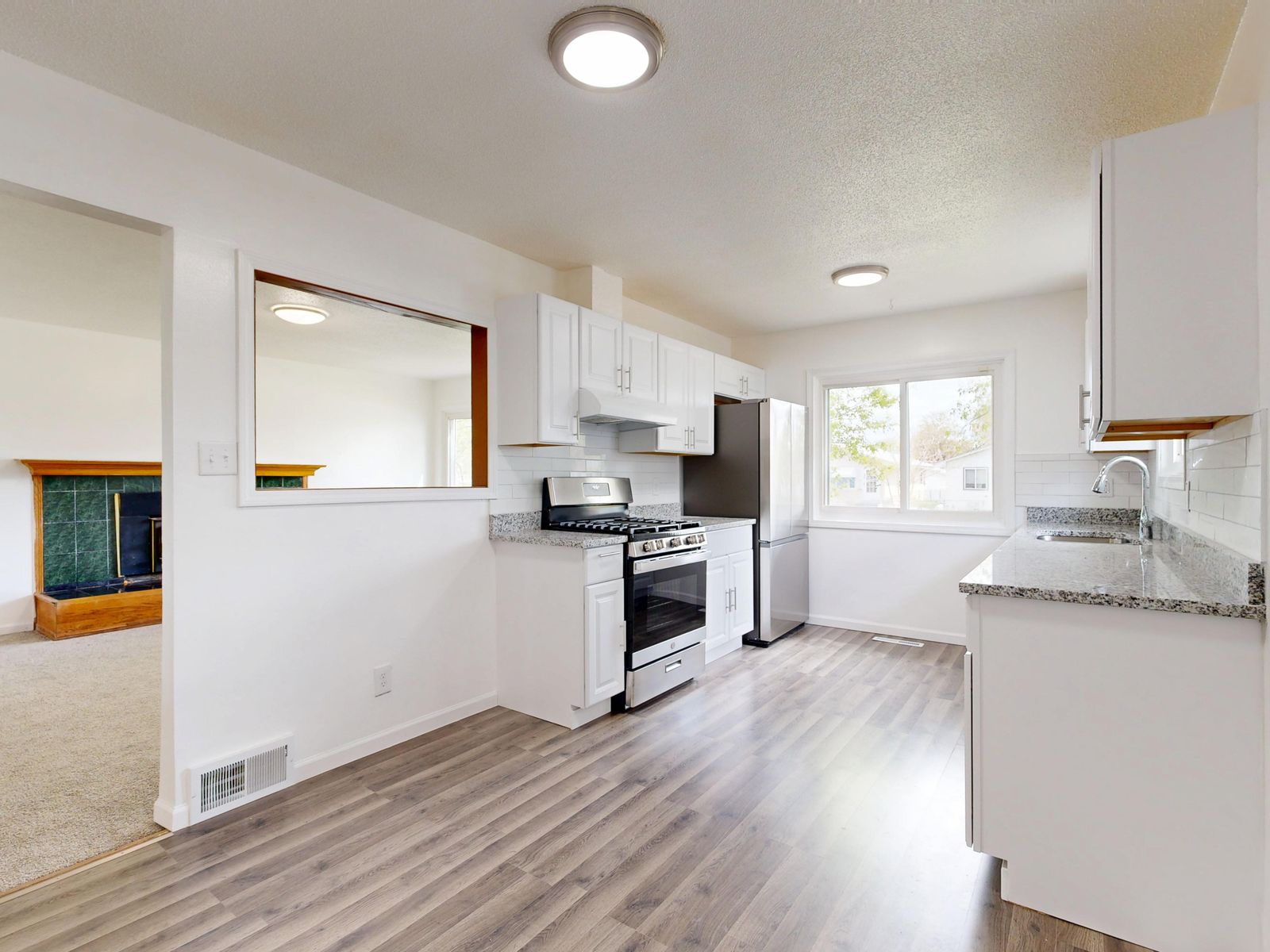 Bright modern kitchen with white cabinets and quartz countertops